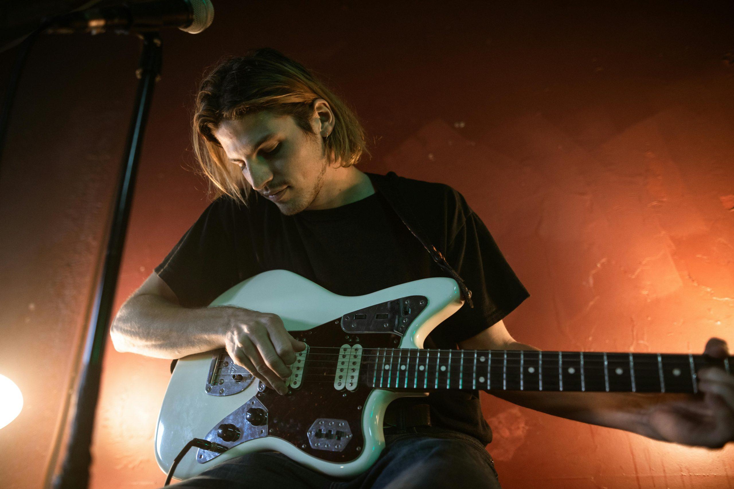 Male musician playing an electric guitar, representing creatives joining the Murray Arts Creative Directory.